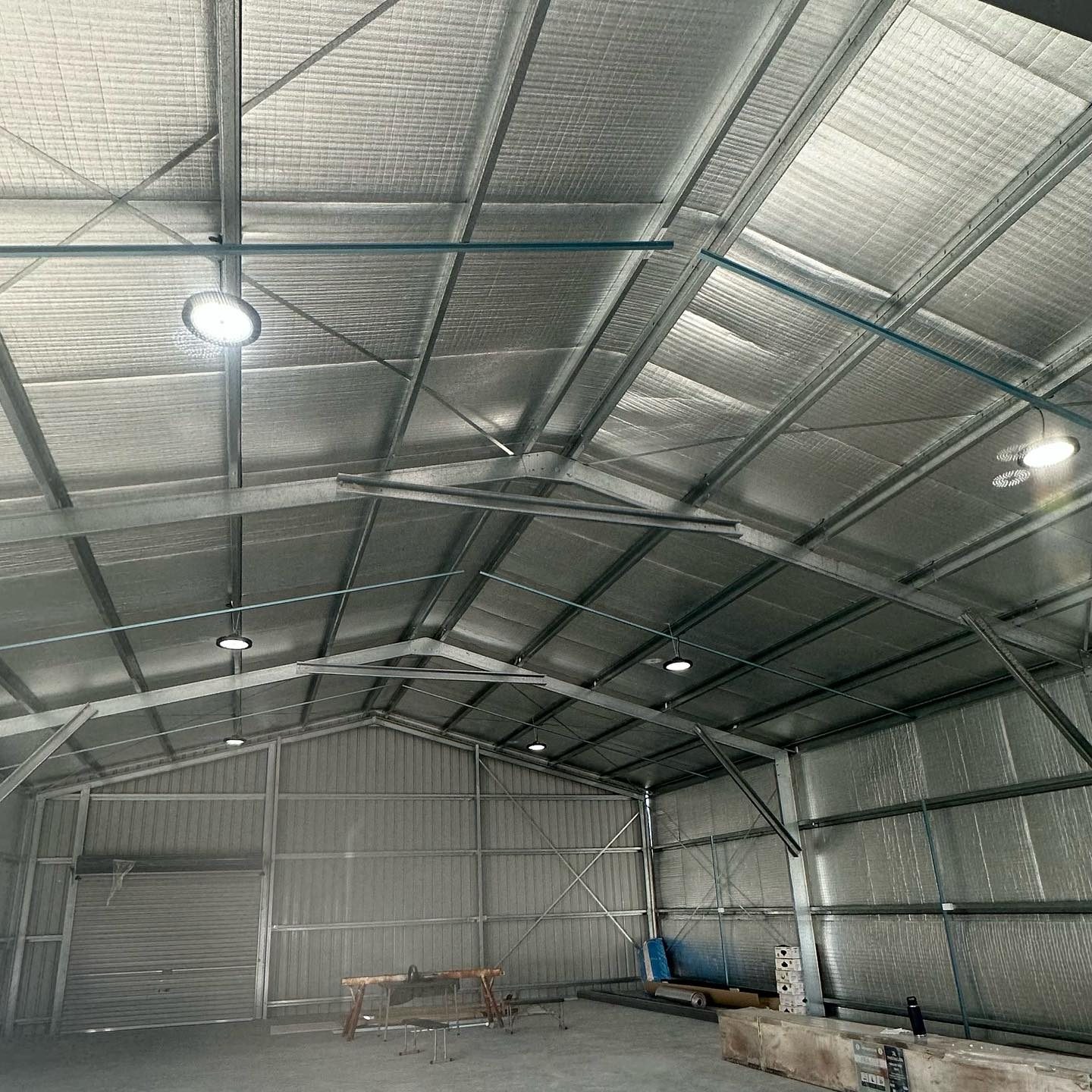 A large shed interior fitted out with new LED high bay lights and ceiling fans