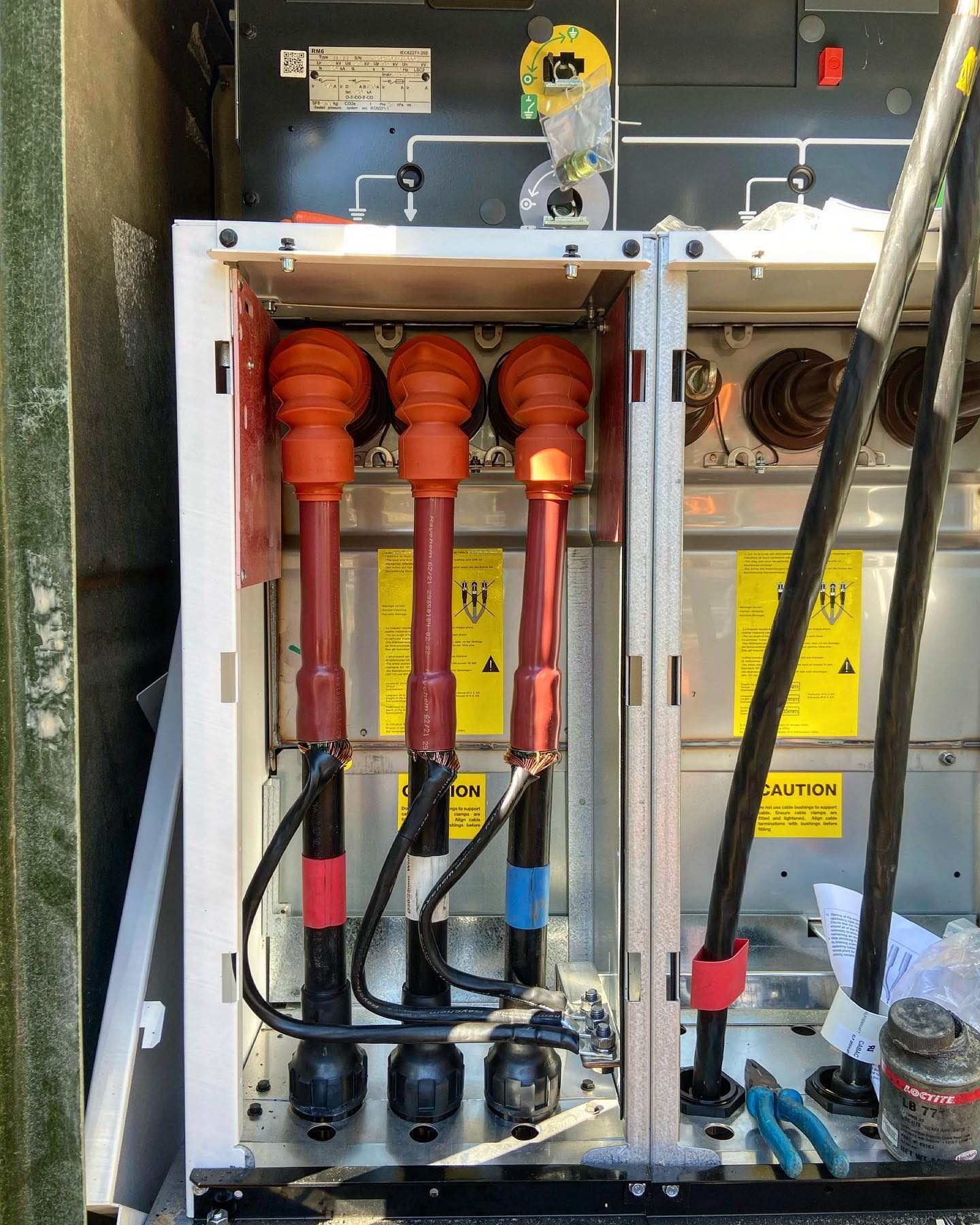 An open service pillar with high voltage cable terminations part way through a jointing job