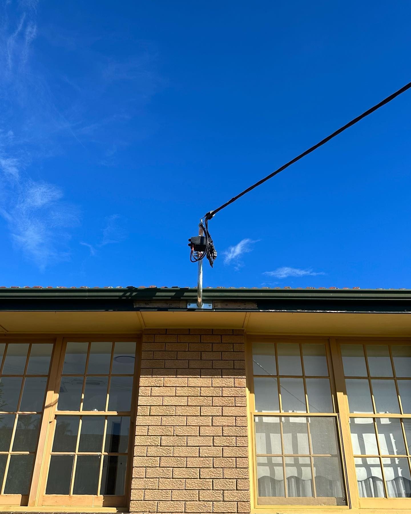 A new overhead service attachment fitted high on a brick building